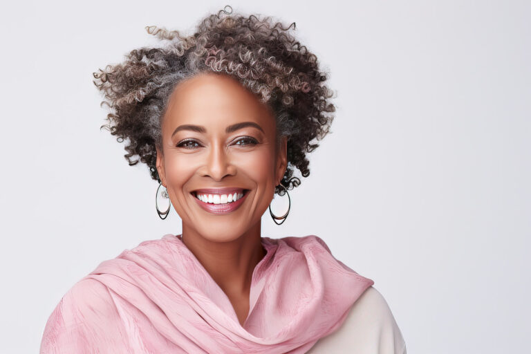 Middle-aged woman with a short gray hairdo looking at camera.